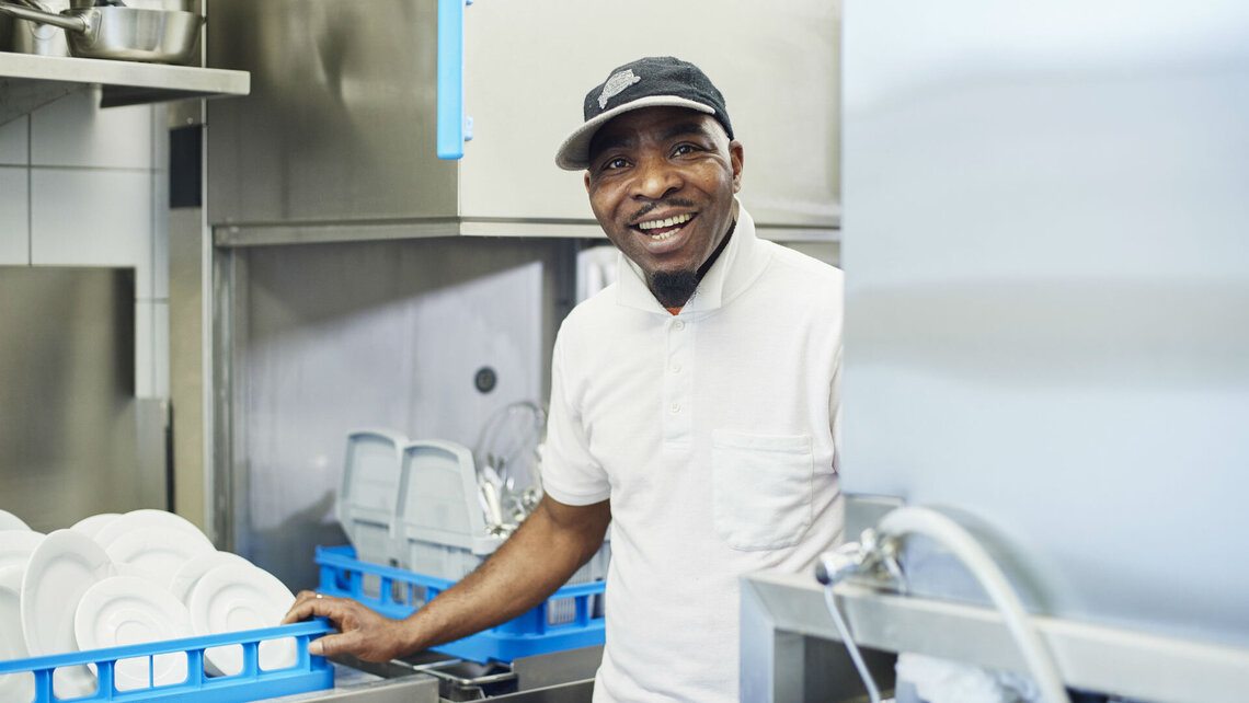 Mamazougou Nadijou in the wash-up area The new M-iClean H hood type dishwashing machine