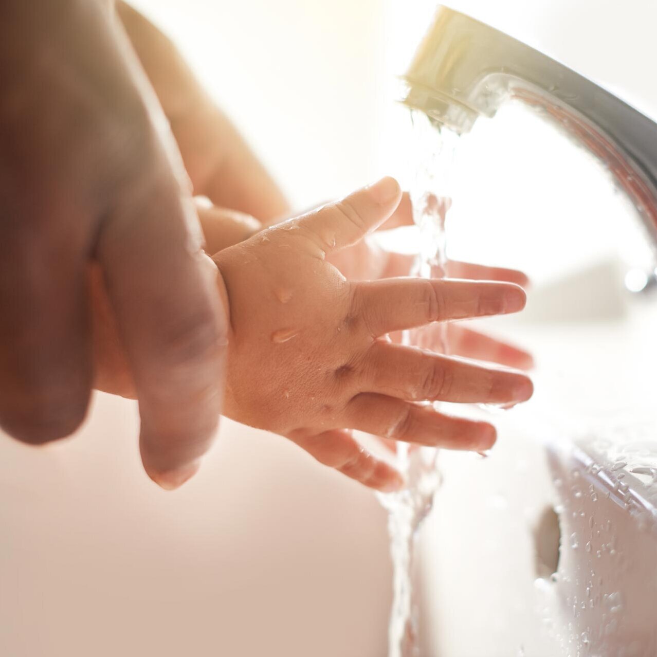 Water flows through children's hands Water flows through children's hands